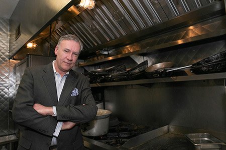 Restaurant manager standing next to EcoThermal Filters